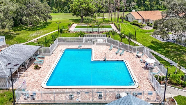 community pool featuring fence and a patio