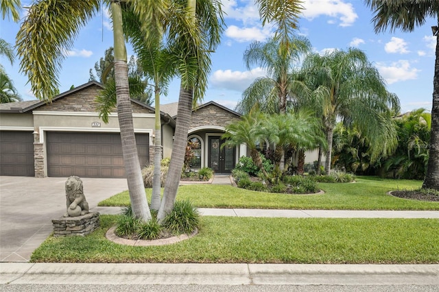 view of front of property with a garage and a front yard