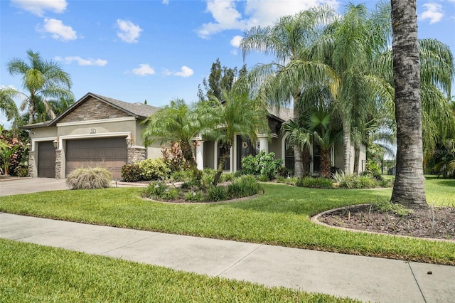 view of front of house with a garage and a front lawn