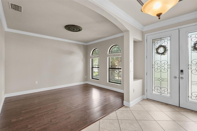 foyer featuring light hardwood / wood-style floors and ornamental molding