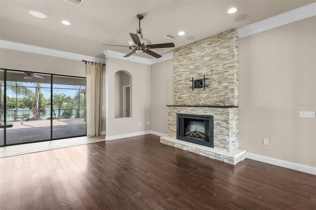 unfurnished living room with a fireplace, ceiling fan, wood-type flooring, and ornamental molding