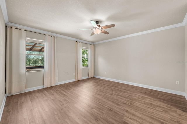 empty room with wood-type flooring, a textured ceiling, crown molding, and ceiling fan