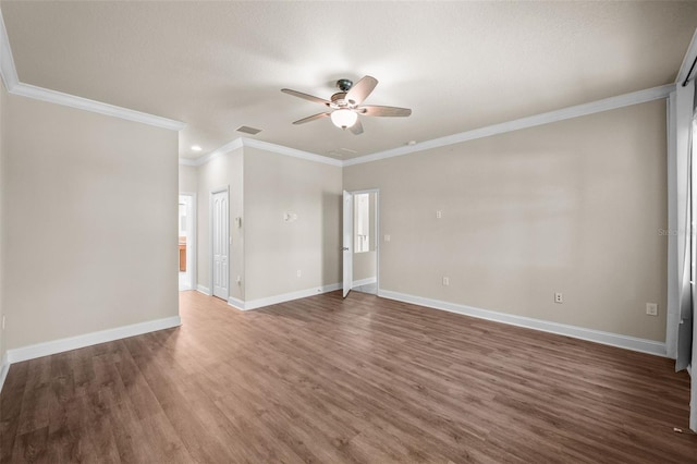 spare room featuring wood-type flooring, ceiling fan, and crown molding