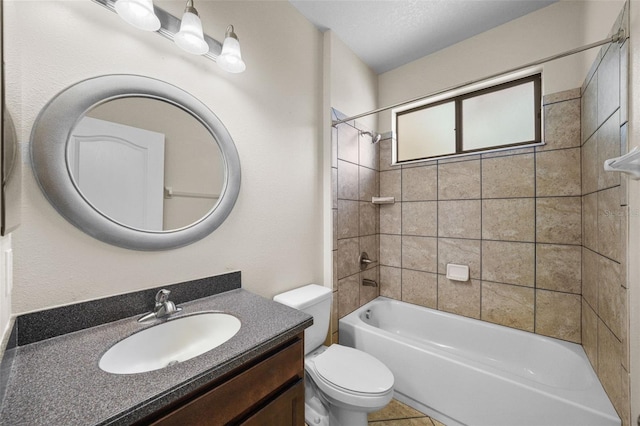 full bathroom with toilet, tiled shower / bath combo, and vanity