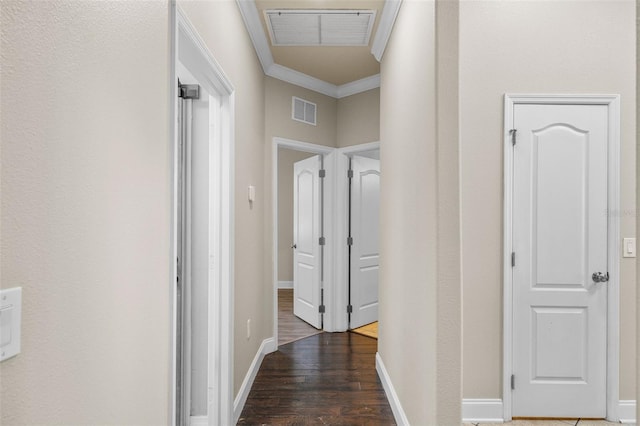 corridor with dark wood-type flooring and ornamental molding