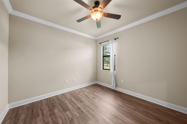 empty room with crown molding, hardwood / wood-style floors, and ceiling fan