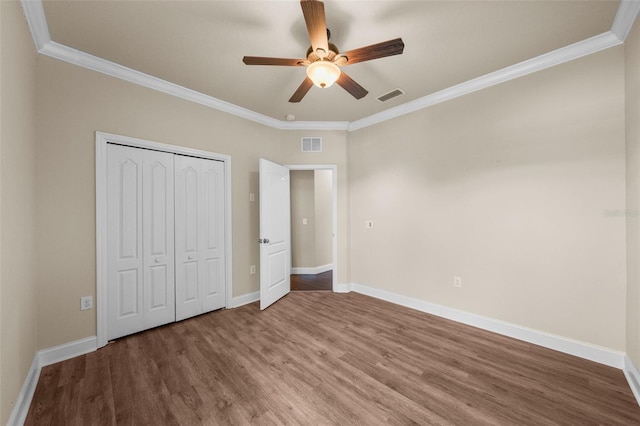 unfurnished bedroom with wood-type flooring and ornamental molding