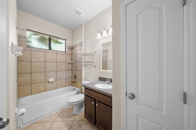 full bathroom with vanity, tiled shower / bath, toilet, and tile patterned floors