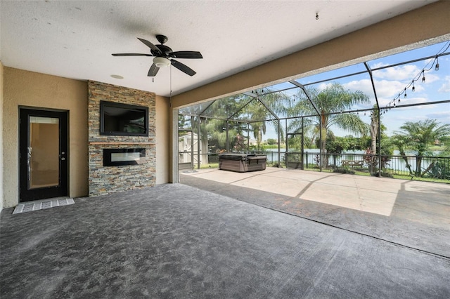 unfurnished living room with plenty of natural light, a textured ceiling, carpet floors, and ceiling fan