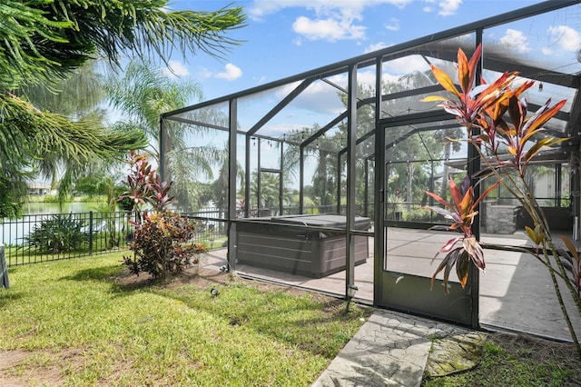 view of yard featuring a lanai and a hot tub