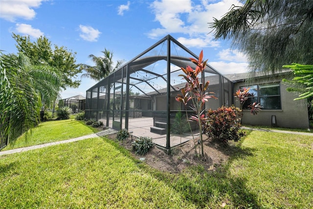 exterior space with a yard and glass enclosure