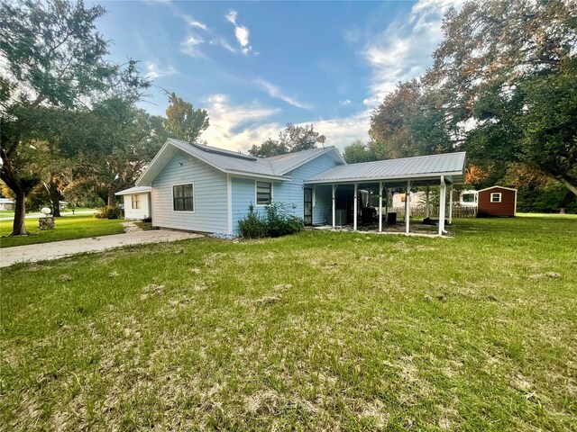 13659 SW 115th Pl, Dunnellon, FL 34432 - back of house featuring a yard and metal roof