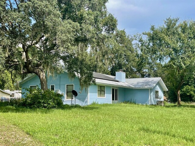 13659 SW 115th Pl, Dunnellon, FL 34432 - view of front of property with a chimney and metal roof