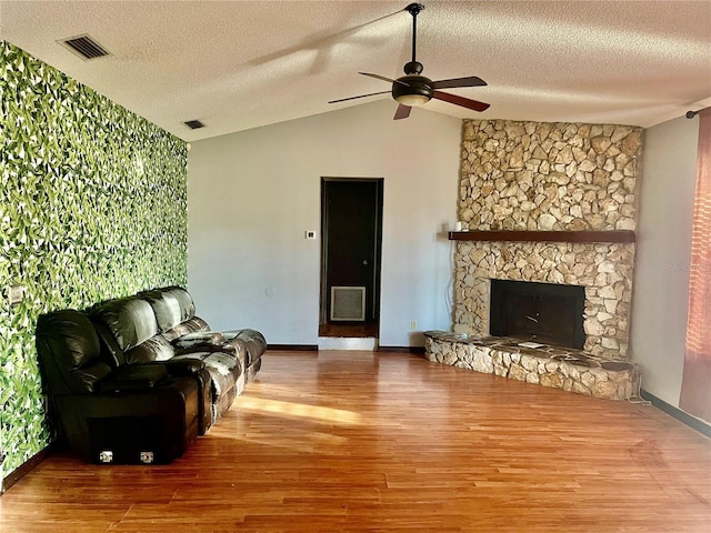 13659 SW 115th Pl, Dunnellon, FL 34432 - living room with vaulted ceiling, a ceiling fan, wood finished floors, baseboards, and a textured ceiling
