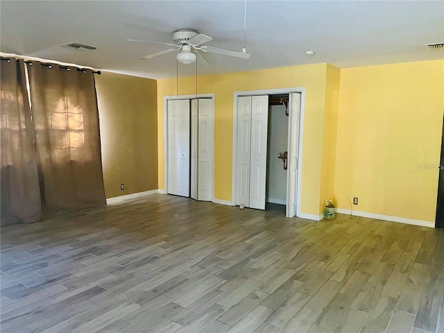 13659 SW 115th Pl, Dunnellon, FL 34432 - unfurnished bedroom with wood finished floors, two closets, and baseboards