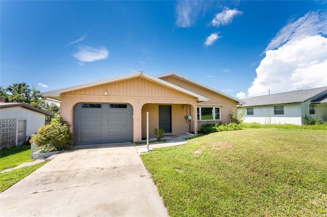 ranch-style house featuring a garage and a front lawn