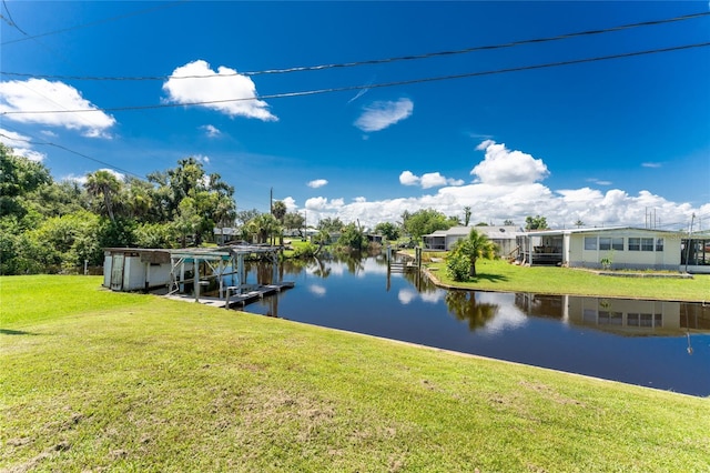 dock area with a water view and a lawn