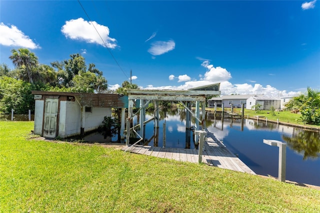 view of dock featuring a water view and a lawn