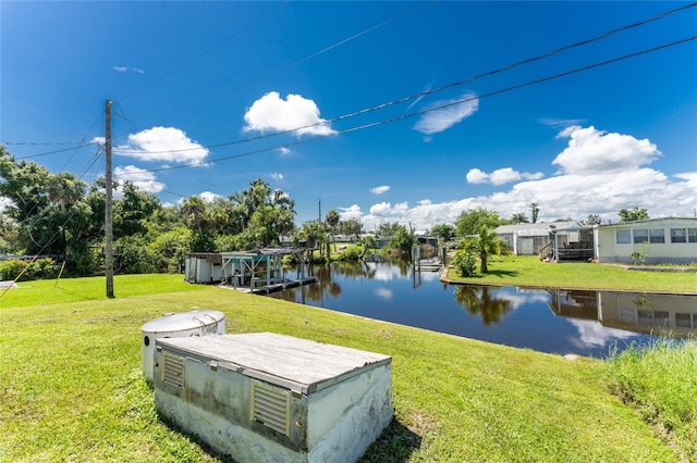 view of dock featuring a water view and a lawn