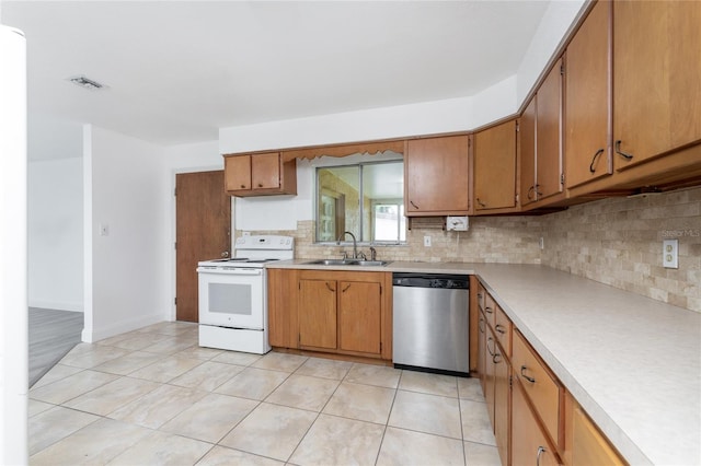 kitchen with sink, light tile patterned floors, backsplash, white electric range oven, and stainless steel dishwasher