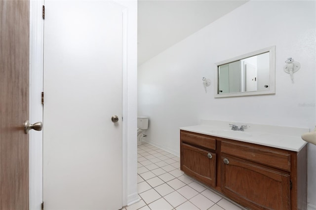 bathroom featuring tile patterned flooring, toilet, and vanity