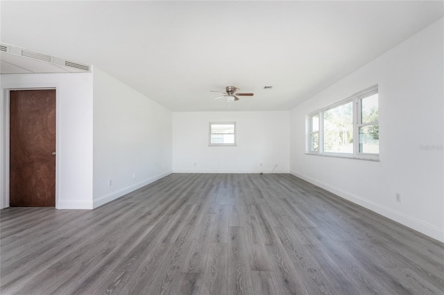 empty room with hardwood / wood-style flooring and ceiling fan