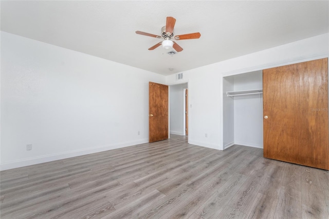 unfurnished bedroom with a closet, ceiling fan, and light wood-type flooring