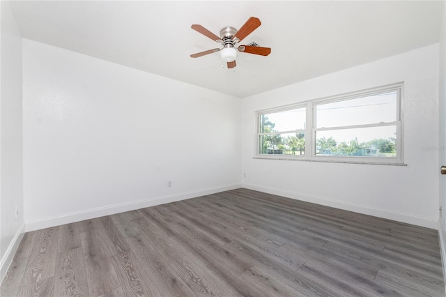 spare room featuring hardwood / wood-style floors and ceiling fan