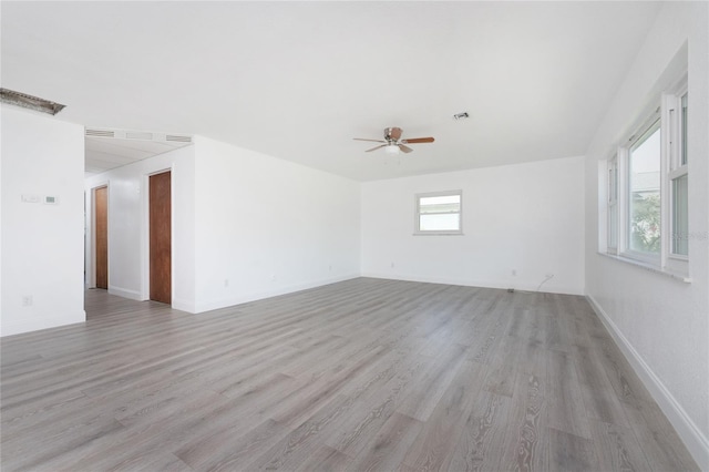 spare room featuring light hardwood / wood-style floors and ceiling fan