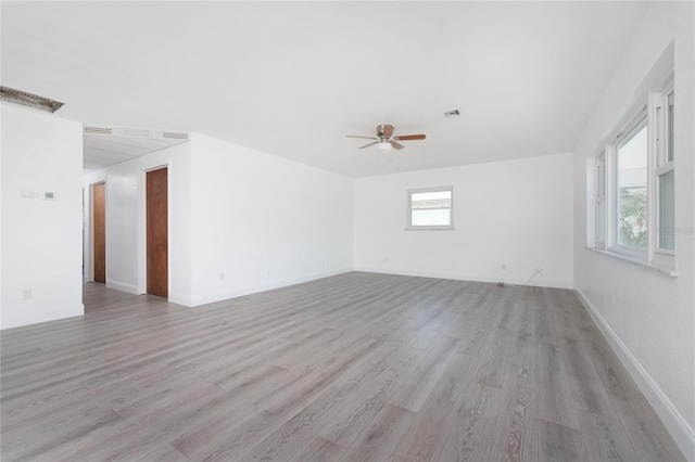 spare room with ceiling fan and light wood-type flooring