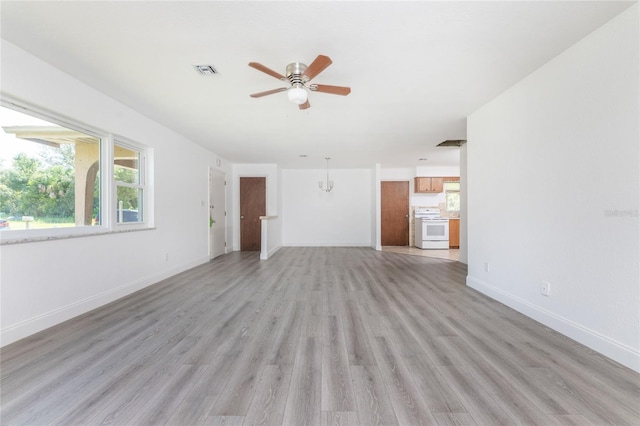 unfurnished living room with ceiling fan and hardwood / wood-style floors