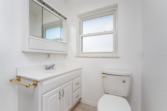 bathroom with tile patterned flooring, vanity, and toilet