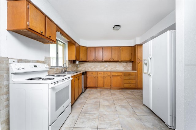 kitchen with tasteful backsplash, sink, white appliances, and light tile patterned floors