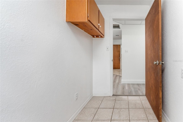 corridor with light tile patterned flooring