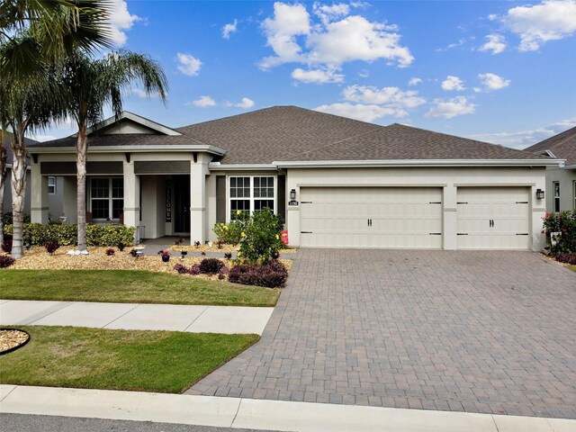 view of front of home featuring a garage and a front lawn