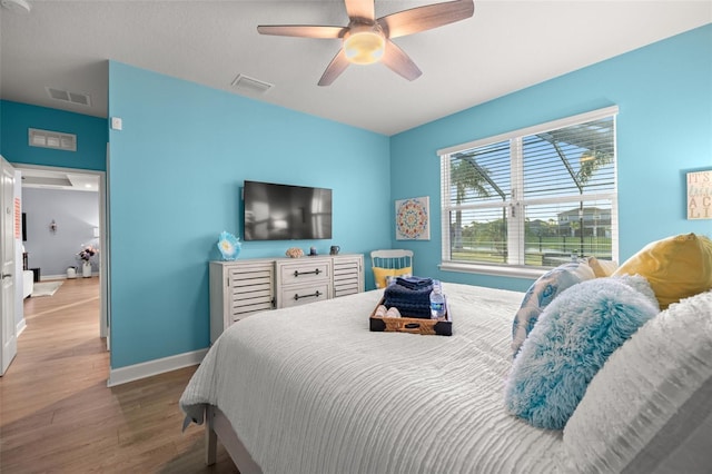 bedroom with ceiling fan and wood-type flooring