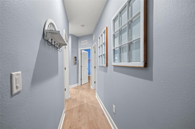 hall with light wood-type flooring