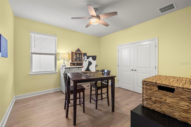 dining room with ceiling fan and light wood-type flooring