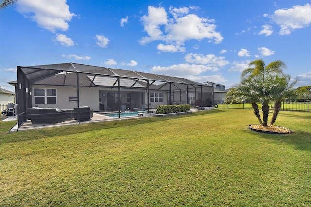 back of property with glass enclosure, a yard, an outdoor hangout area, a fenced in pool, and a patio