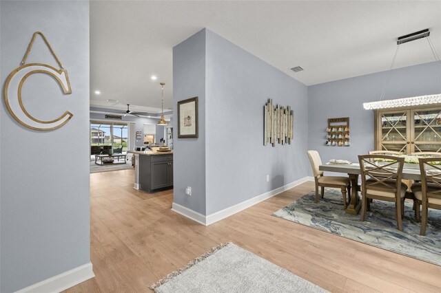 dining room featuring light hardwood / wood-style floors and ceiling fan