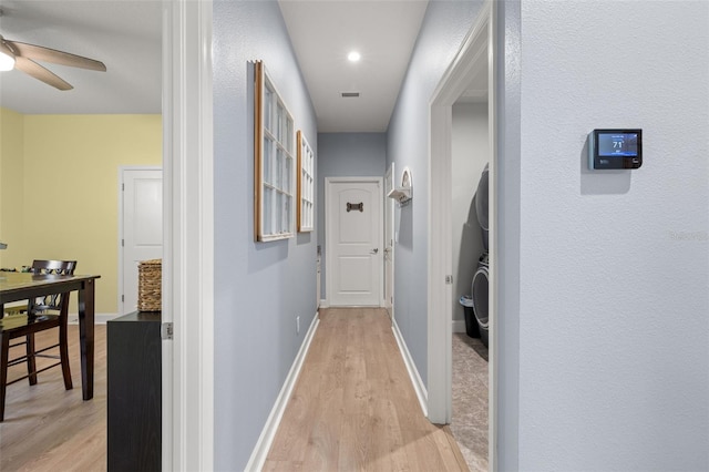 hallway with light hardwood / wood-style flooring