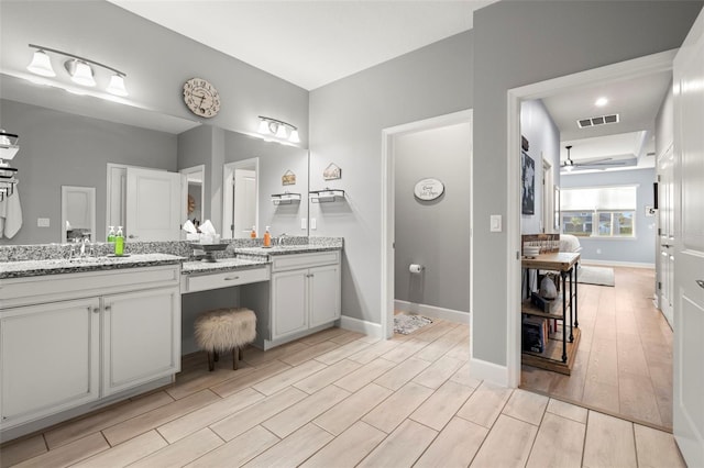 bathroom with ceiling fan and vanity