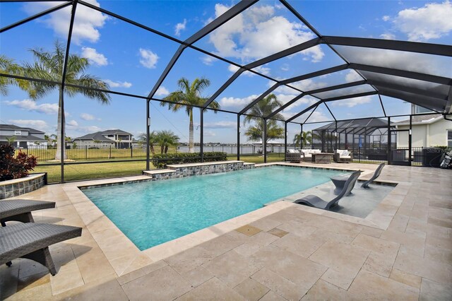 view of pool with a patio, pool water feature, and glass enclosure