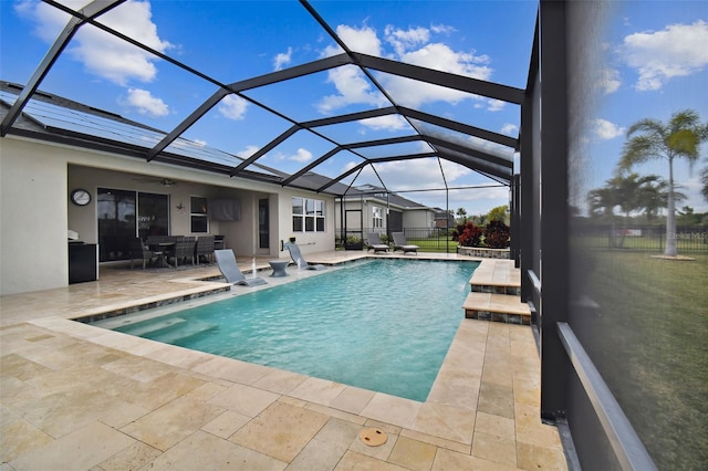 view of swimming pool featuring a lanai and a patio area