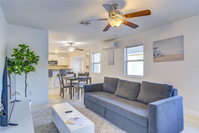 living room with a wall unit AC and ceiling fan