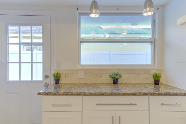 interior space featuring tasteful backsplash and plenty of natural light