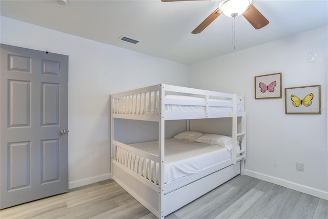 bedroom with light hardwood / wood-style flooring and ceiling fan