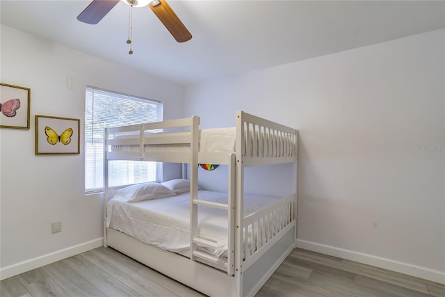 bedroom with light hardwood / wood-style floors and ceiling fan