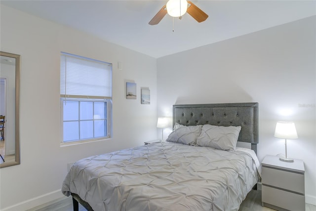 bedroom with light hardwood / wood-style floors and ceiling fan