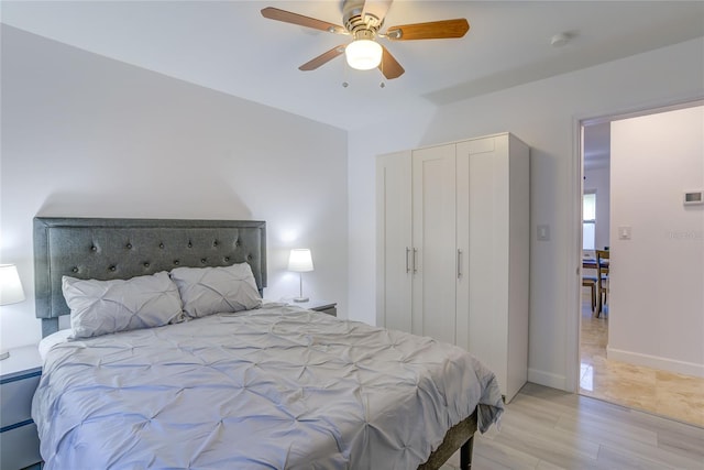 bedroom with light hardwood / wood-style floors and ceiling fan